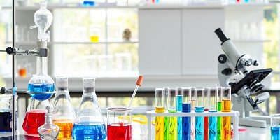 Chemical Liquid test tube and Microscope in Laboratory.