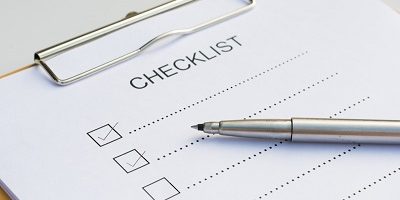 Checklist concept – checklist, paper and a pen with checklist wo